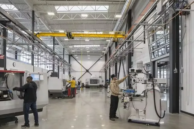 Students working at machines inside Building 24