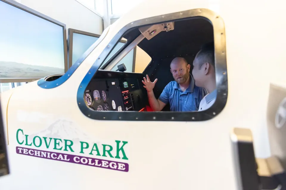 An instructor and a student in the cockpit of a CPTC aircraft