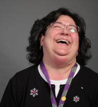 Lucy Dorum. Picture of woman with her head back laughing.